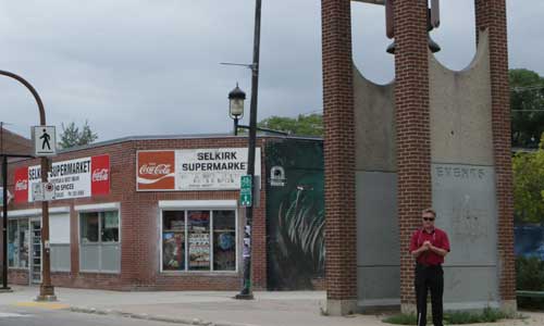 Ross in front of the Powers Park Bell Tower with a new roof due to his work with the Selkirk Avenue BIZ- murals are moving ahead for 2015. The bell in the tower is the bell from the old Winnipeg ginger bread city hall