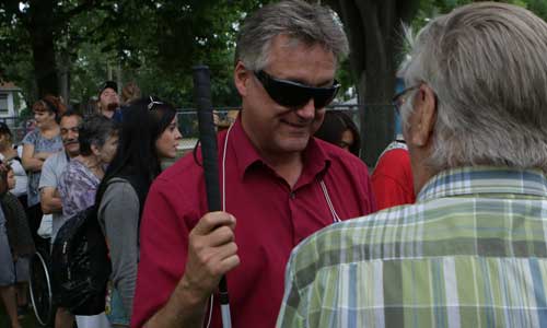 Ross speaking to barbecue attendees at Machray Park put on by the North end Family Centre, an organization the councillor tries to assist in their work with people of the North End.